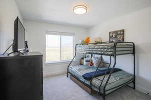 Bedroom with light carpet and baseboards