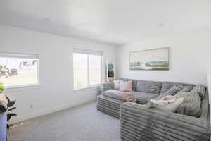 Living area featuring baseboards and carpet flooring