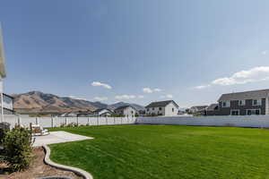 Fenced backyard with a residential view and a patio