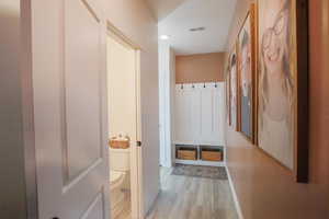 Mudroom featuring light wood-style floors and baseboards