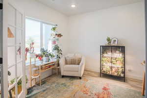Living area with wood finished floors and recessed lighting