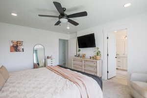 Bedroom featuring recessed lighting, ceiling fan, ensuite bathroom, and light wood-style floors