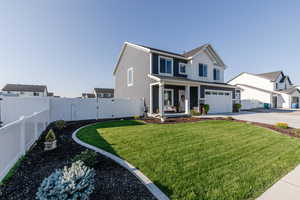 View of front of home with a porch, a garage, and driveway