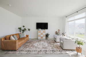 Living area with wood finished floors and baseboards