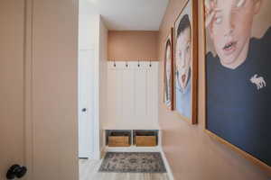 Mudroom featuring light wood-style floors
