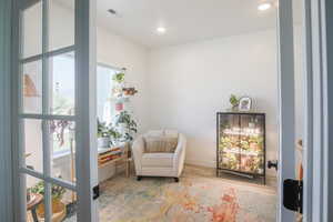 Living area featuring wood finished floors and recessed lighting