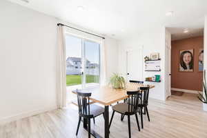 Dining space featuring light wood-type flooring and recessed lighting