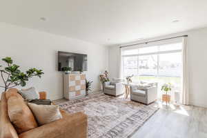 Living area with wood finished floors and baseboards