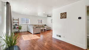 Living room with wood finished floors, recessed lighting, and ceiling fan