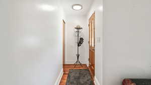 Hall featuring wood finished floors and baseboards