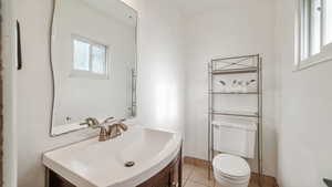 Half bath featuring vanity and light tile patterned floors