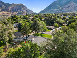 Aerial overview of property's location featuring a mountainous background and nearby suburban area