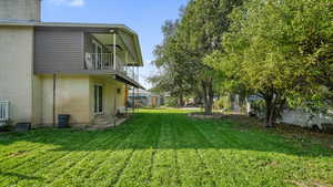 View of yard featuring a balcony