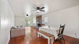 Dining room featuring dark wood-style flooring and a ceiling fan