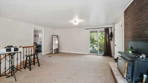 Living room with light carpet and a wood stove