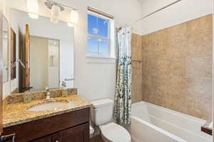 Full bath featuring shower / tub combo and vanity