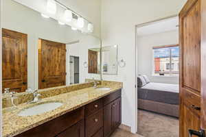 Ensuite bathroom with double vanity and a closet