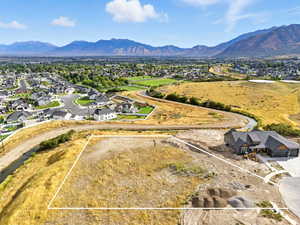 Aerial view of residential area with a mountainous background and property boundaries highlighted