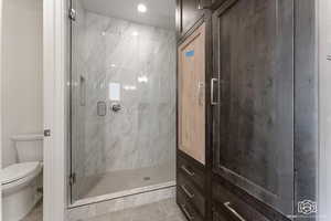 Bathroom featuring a stall shower and light tile patterned flooring