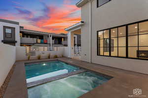 View of swimming pool featuring a patio area and a pool with connected hot tub