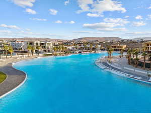 Community pool featuring a mountain view, a patio, and a residential view