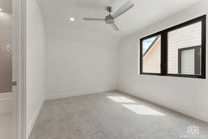 Spare room with light colored carpet, recessed lighting, a ceiling fan, and lofted ceiling