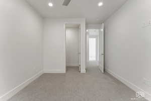 Unfurnished bedroom with light carpet, recessed lighting, and a ceiling fan