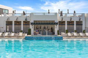 Community pool featuring a hot tub and a patio area