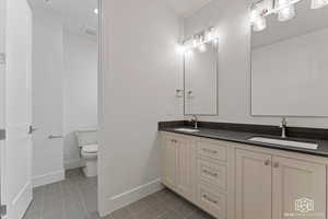 Bathroom featuring light tile patterned floors and double vanity