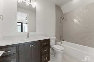 Bathroom with shower / tub combination, vanity, and light tile patterned floors