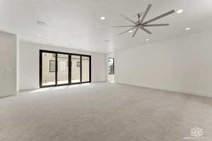 Spare room with light carpet, recessed lighting, a textured ceiling, and a ceiling fan