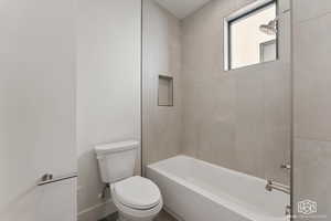 Full bath featuring tub / shower combination and toilet