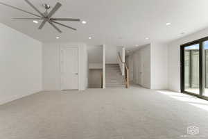 Unfurnished living room with stairs, recessed lighting, light carpet, and ceiling fan
