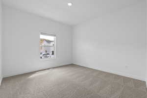 Unfurnished room featuring light colored carpet and recessed lighting