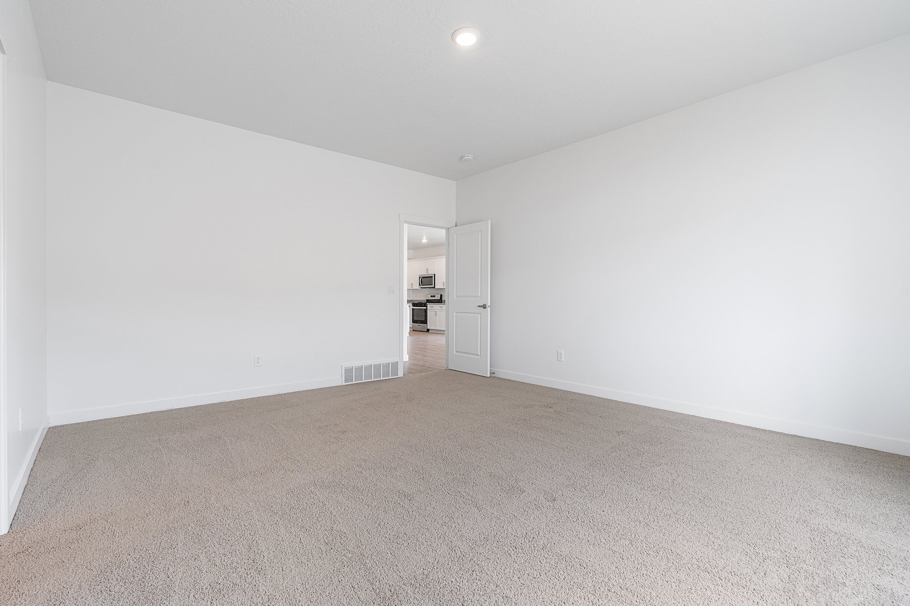 Empty room with carpet flooring and recessed lighting
