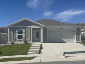 Ranch-style house featuring concrete driveway, a garage, board and batten siding, a shingled roof, and a porch