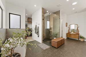 Bathroom with a stall shower, recessed lighting, and dark tile patterned flooring