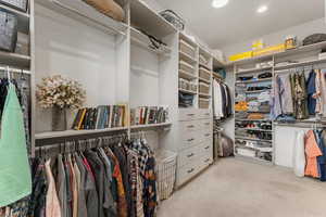 Spacious closet with light colored carpet