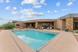 View of swimming pool featuring a patio and a pool with connected hot tub