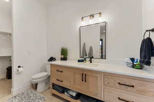 Bathroom featuring vanity and toilet