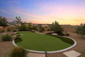 View of home's community with a putting green
