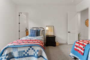 Carpeted bedroom featuring baseboards