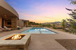 View of swimming pool featuring a patio, a pool with connected hot tub, and a mountain view