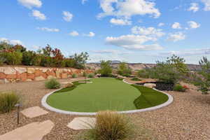 View of yard featuring a putting area and a mountain view