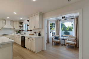Kitchen with decorative backsplash, open shelves, light wood-style floors, custom range hood, and recessed lighting