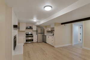 View of kitchen and fireplace in basement