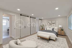 Bedroom with a barn door, light carpet, and recessed lighting