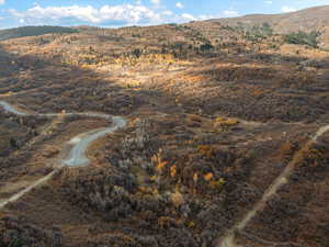 Aerial view of property and surrounding area with a mountainous background