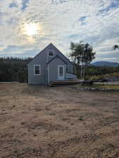 View of side of home featuring a wooden deck
