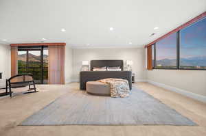 Primary bedroom with a mountain view, recessed lighting, access to exterior, and crown molding
